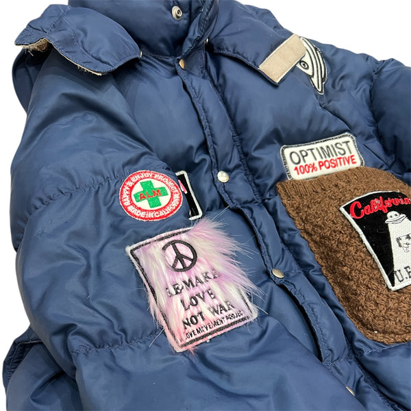 A Love Movement Puffer Jacket with fun patches