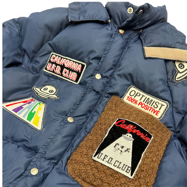 A Love Movement Puffer Jacket with fun patches